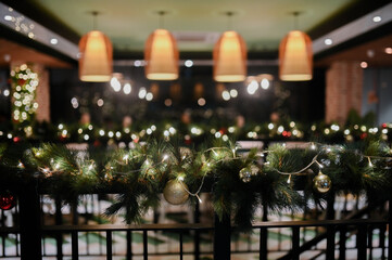 Christmas decoration details on a public vintage restaurant for holiday ambience with hanging lamp