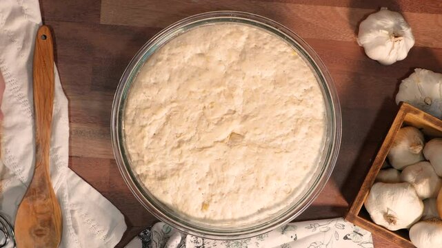 Making garlic bread with simple ingredients like flour, yeast, water, salt and garlic.  Mixing, kneading and baking garlic bread in loaves.  Baking and making bread.