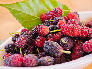 The mulberry is red and black in bowl