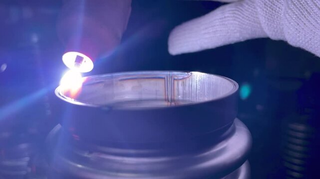Process of argon welding flexible stainless steel pipe with nozzle close-up.