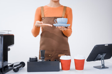 Asian female barista with a beautiful smile, skillfully making coffee in a cozy small shop, creating a warm and welcoming atmosphere for customers in the charming cafe