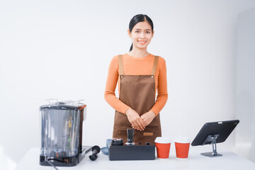 Asian female barista with a beautiful smile, skillfully making coffee in a cozy small shop, creating a warm and welcoming atmosphere for customers in the charming cafe