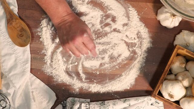 Making garlic bread with simple ingredients like flour, yeast, water, salt and garlic.  Mixing, kneading and baking garlic bread in loaves.  Baking and making bread.