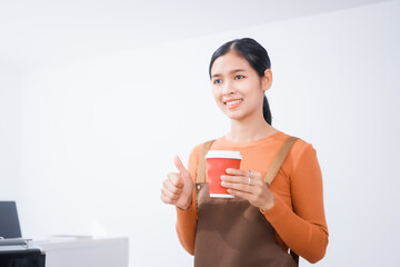 Asian female barista with a beautiful smile, skillfully making coffee in a cozy small shop, creating a warm and welcoming atmosphere for customers in the charming cafe
