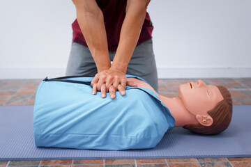 A female demonstrates CPR using dummy during life-saving training sessions,equipping participants with essential emergency skills ensure safety, provide critical care,respond effectively emergencies