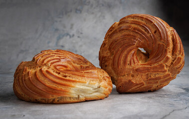 Two profiterole cakes. Eclair in the shape of a ring.