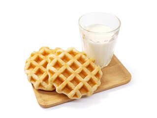 Round waffles on wooden tray with a milk glass isolated on white background