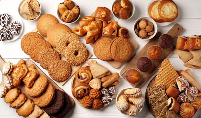 Assortment of baked goods displayed on a wooden surface with various styles and flavors