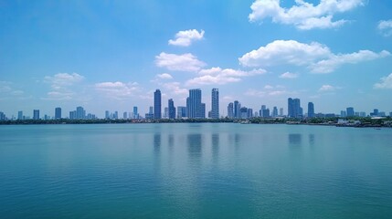 Modern City Skyline Reflected on Calm Water Under Blue Sky