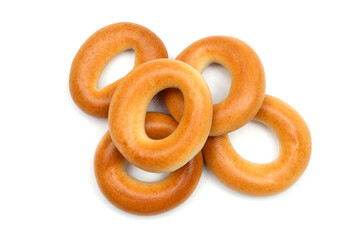 A pile of small dry bagels on a white background. Close-up of bagels.