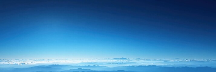 Fototapeta premium Aerial view of blue sky and mountain range with clouds in a clear day from above