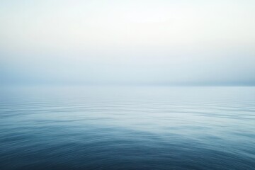 Obraz premium Gentle waves whisper secrets under a serene, foggy horizon at dawn near the still waters of a tranquil lake. Generative AI