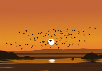 
Flock of birds flying over the beach