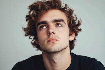 Fototapeta premium Thoughtful suspicious young man looking aside at copyspace feeling skeptic, Generative AI