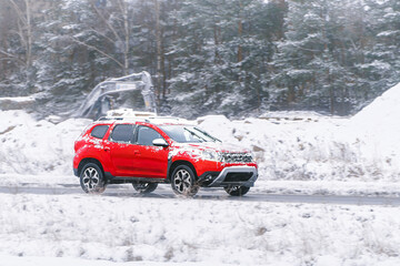 SUV driving on snowy winter road