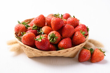 Strawberry fruit in basket on white background