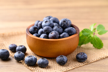 Blueberries in wooden bowl on wooden table, Healthy fruit, Food ingredient
