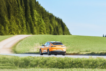 Modern Electric SUV on Countryside Road Surrounded by Greenery