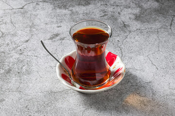 Fresh Turkish Tea in classic tea glass on stone table