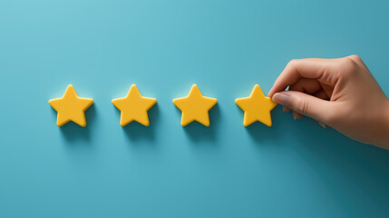 Hand arranging yellow stars on blue background for rating concept