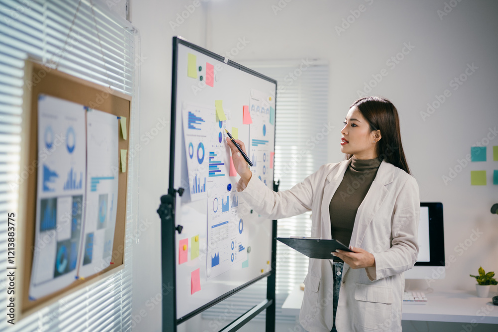 Aufkleber businesswoman analyzing marketing data and pointing at graph on whiteboard during a presentation in 