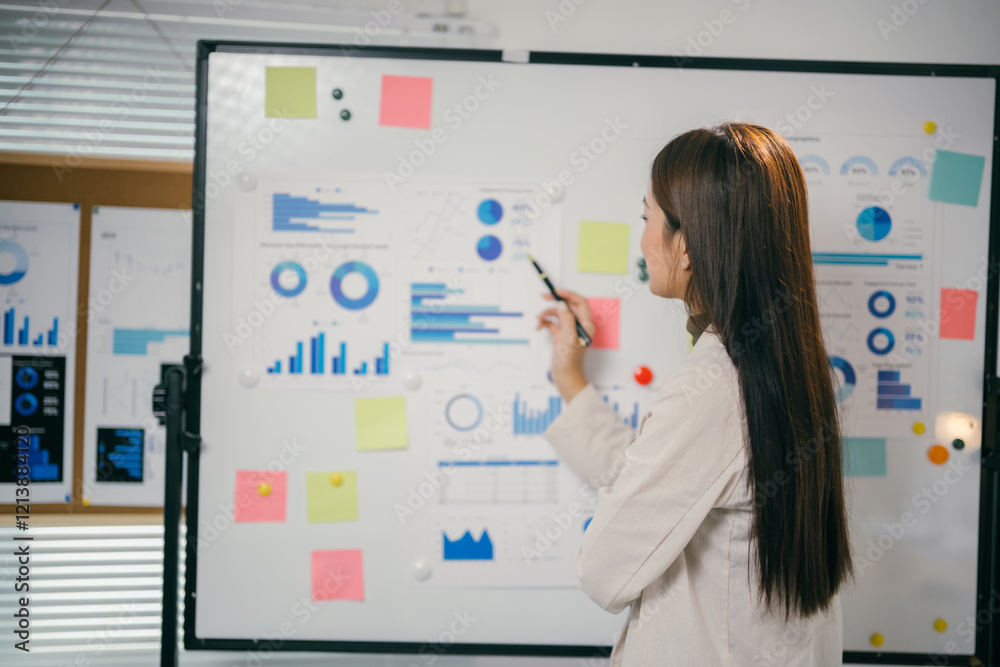 Poster businesswoman analyzing statistical graphs and charts, using pen and sticky notes on whiteboard, pla