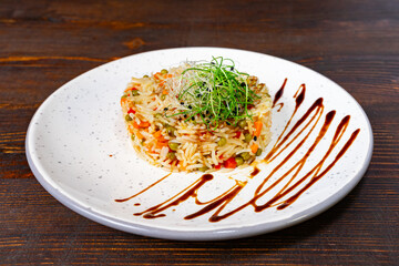 Colorful vegetable rice dish elegantly plated on a white dish Savory vegetable pie served with...