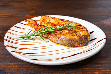 Deliciously grilled salmon steak served on a white plate with garnish Savory vegetable pie served with fresh garnishes on a white plate