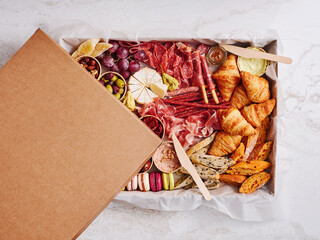 A beautifully arranged charcuterie board features an assortment of cured meats, gourmet cheeses, fresh fruits, and baked goods. Ideal for sharing at gatherings or celebrations