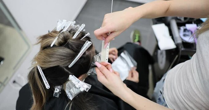 Hair styling session with foil highlights in a salon