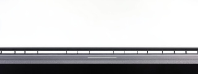 Low-angle view of a highway overpass against a bright white sky.