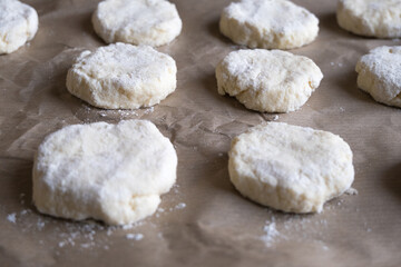 Raw cookies molded from dough on baking paper. Preparing to bake cookies.