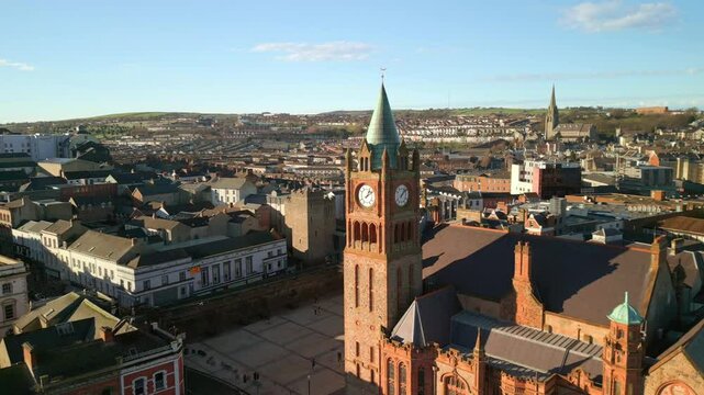 Aerial shot of the Guildhall in Derry-Londonderry, NI. The camera begins tight on the clock tower and reverses to reveal the city. Filmed in 4K at 60fps and in Rec709 color space.