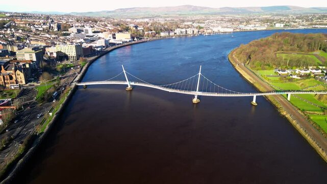 Right to left ultra wide aerial shot of the Peace Bridge in Derry-Londonderry, NI. Filmed in 4K at 30fps and in Rec709 color space.