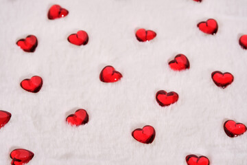Abstract textured background with hearts on a white plush background.