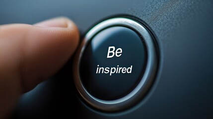 Black "Be inspired" button in low light. Great for creativity and motivation themes.