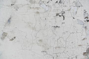 Cracked and Chipped White Paint on a Weathered Wall