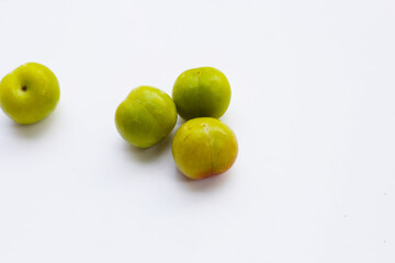 Fresh green plum on white background