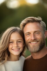 Fototapeta premium Smiling man and girl share joyful moment outdoors, showcasing wa