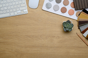 Minimalist workspace with color palettes, wooden samples, and a succulent plant