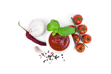 Culinary still life with ingredients for preparing tomato sauce on a white background