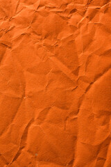 Wrinkled and crumpled orange tissue wrapping paper.