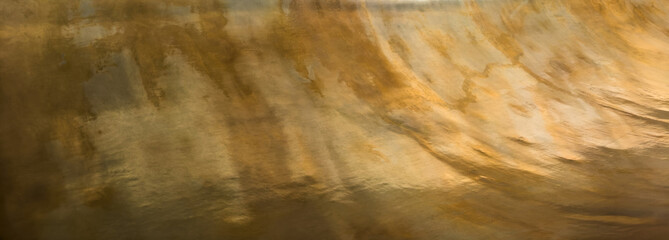 Golden Metal Surface with Swirling Patterns - Artistic Industrial Texture