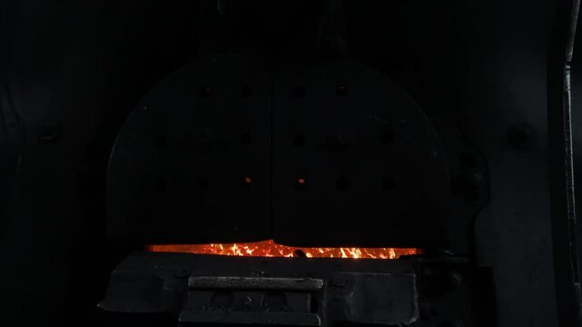 retro steam locomotive firebox with hot roaring fire in the engine showcasing vintage railway power