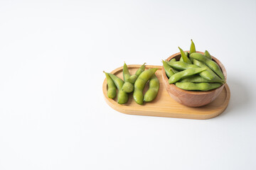Edamame beans in wooden tray and bowl