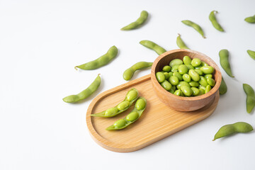 Edamame beans in wooden tray and bowl