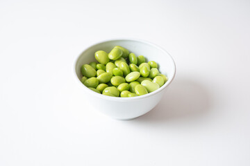 Edamame beans in white bowl
