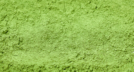 Flat lay of Organic Green tea powder, texture background.