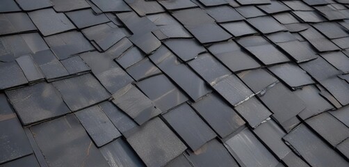 A close-up of black shingles on a metal roof with a contrasting grey accent strip, building materials , industrial decor