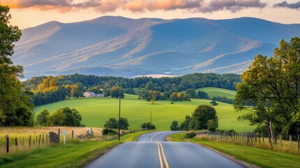 Fototapeta premium Serene Country Road Winding Through Lush Green Hills and Mountains at Sunset.